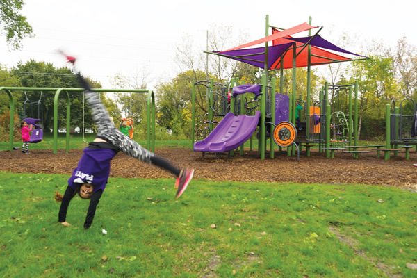 girl doing cartwheel in playground